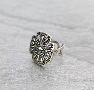 silver cross cuff ring on a gray background