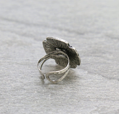 silver cross cuff ring on a gray background