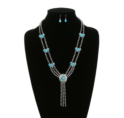 turquoise cluster multi strand silver bead necklace & turquoise bead earrings on a black bust