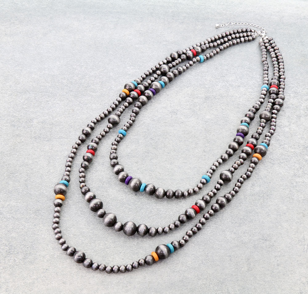 3 layer multi colored necklace on gray background