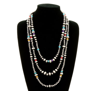3 layer multi colored bead necklace on a black jewelry bust