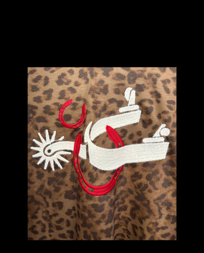 closeup of print with horseshoes & a spur