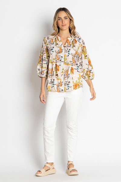 model wearing a white Western print top and white pants