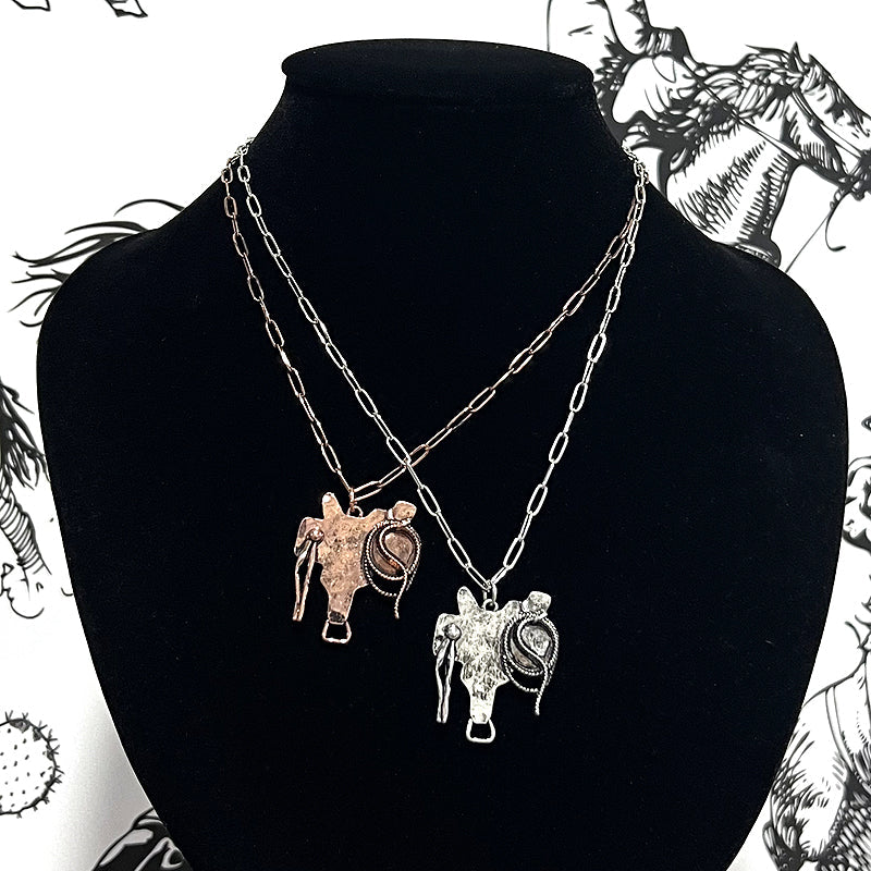 saddle pendant necklaces on black bust