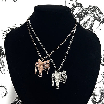 saddle pendant necklaces on black bust