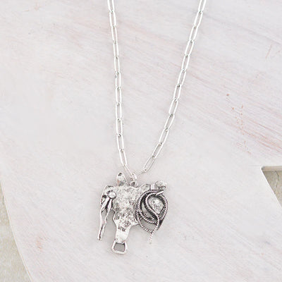 silver saddle pendant necklace on white background