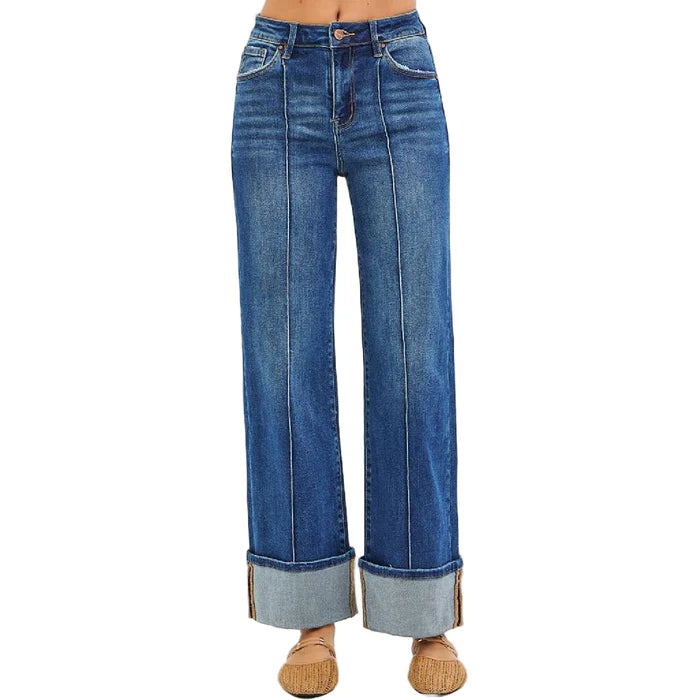 Blue jeans with rolled-up cuffs on a white background