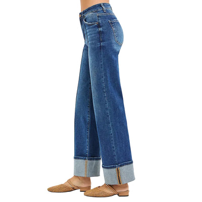 Blue jeans with rolled-up cuffs on a white background