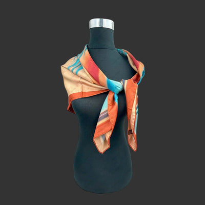 rust and blue stripe scarf shown on dark bust