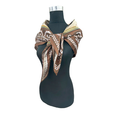 brown and tan scarf tied on dark bust