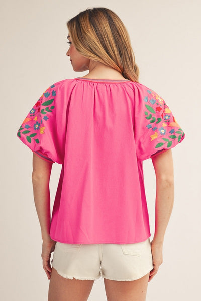 model wearing hot Pink top & cutoff white shorts