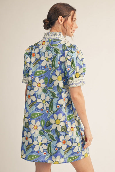 back model wearing a a blue floral shift dress