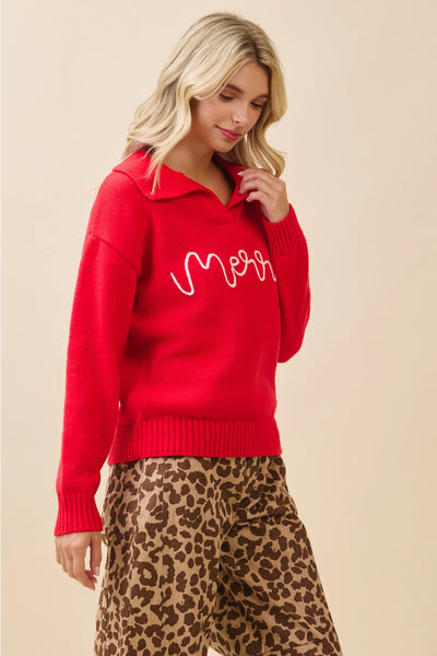 Woman wearing a red sweater with 'Merr' text and leopard print pants on a beige background