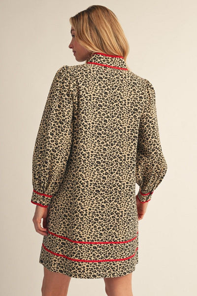 back of model wearing leopard dress with red accents in front of a light background