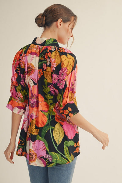 model wearing a floral top & jeans
