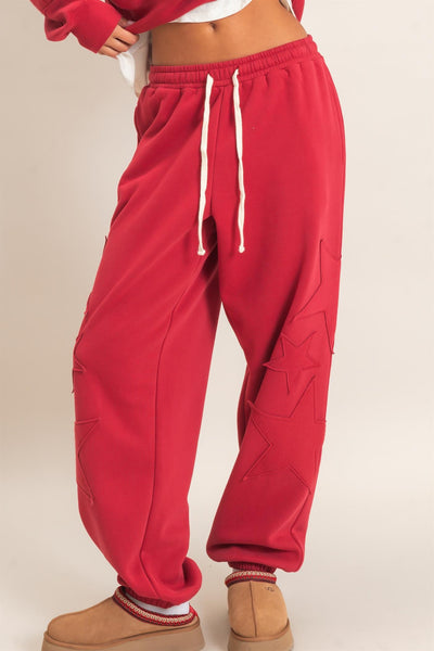 woman wearing red start patch joggers