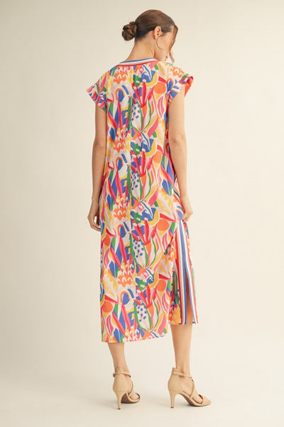 back of model wearing a multicolor print dress with stripes along the side  neckline