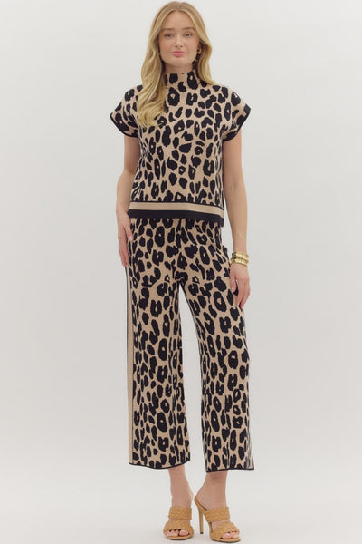 Woman wearing a leopard print outfit on a white background