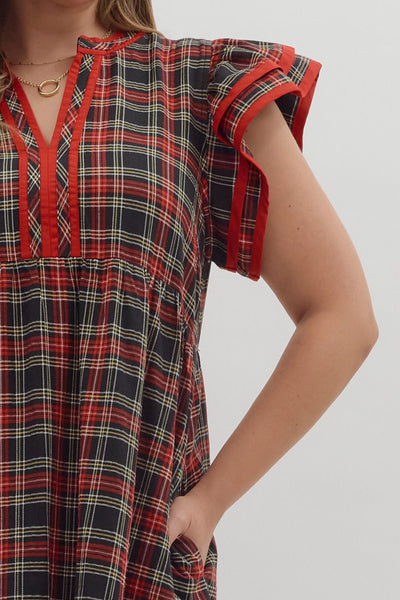 Plaid dress with red accents on a plain background