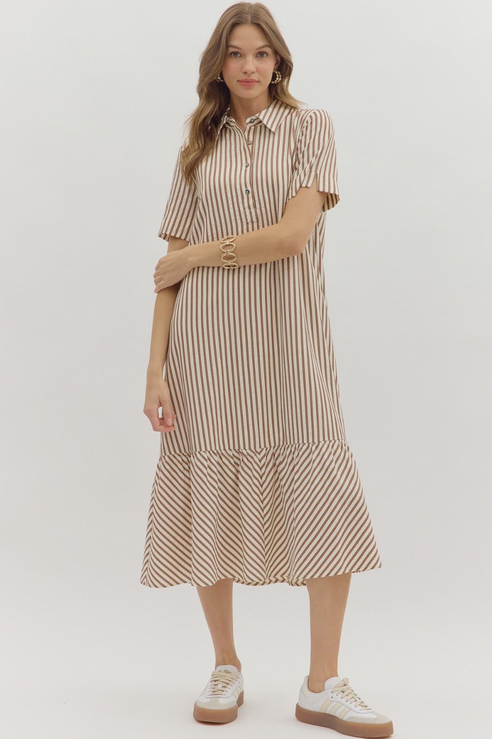 Woman wearing a striped dress on a white background