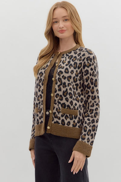 Woman wearing a leopard print cardigan on a plain background