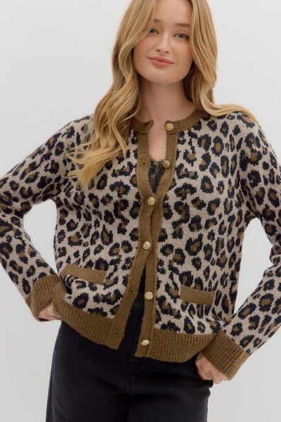Woman wearing a leopard print cardigan with brown buttons on a white background