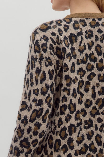 Leopard print sweater worn by a person on a light gray background