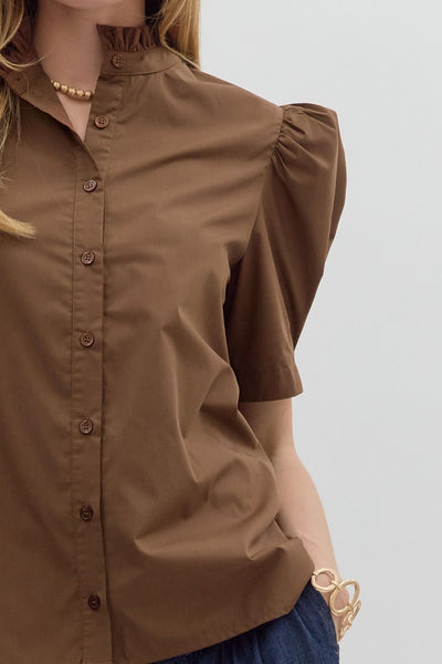 Brown blouse with puff sleeves worn by a person on a light gray background