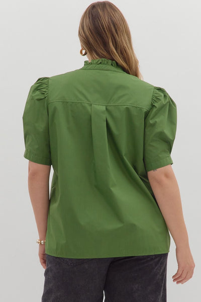 Green blouse with puff sleeves worn by a person on a white background