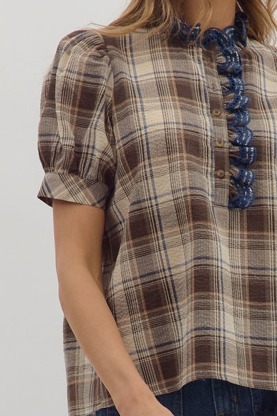 Plaid shirt with blue ruffled trim on a white background