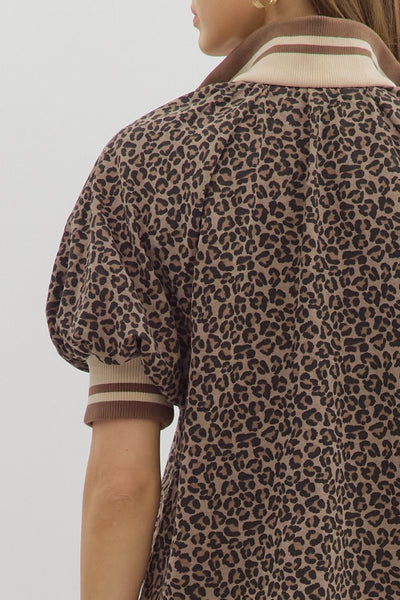 Leopard print jacket worn by a person on a plain background