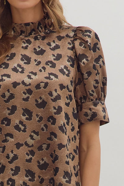 Brown dress with black leopard print pattern on a plain background