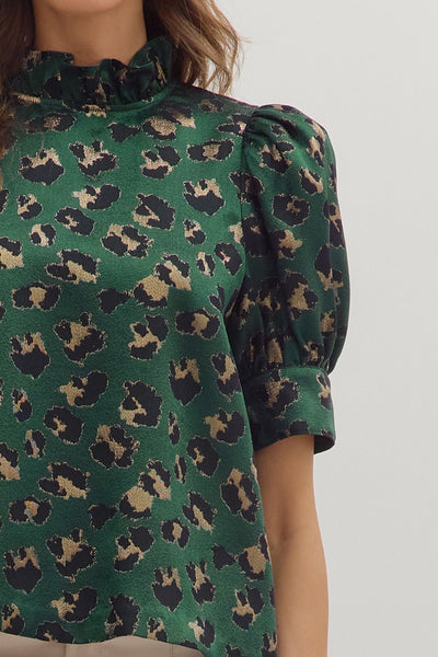 Green blouse with leopard print pattern on a white background