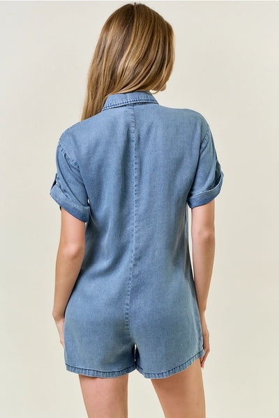 back of model wearing a denim romper against white background