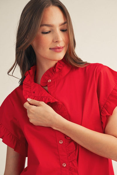 model wearing red blouse with ruffles