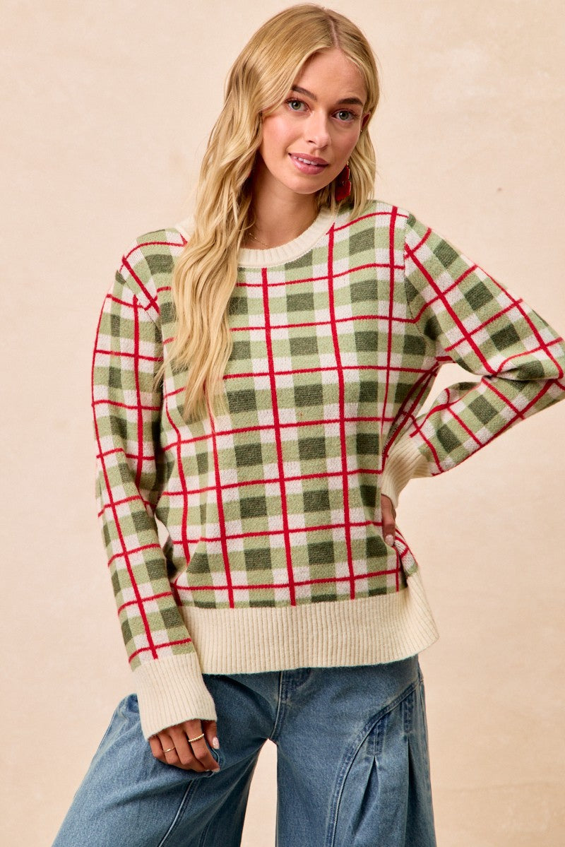 Woman wearing a plaid sweater with green and red pattern on a beige background