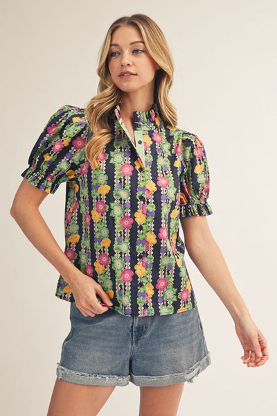 model wearing button down floral top & cuffed denim shorts