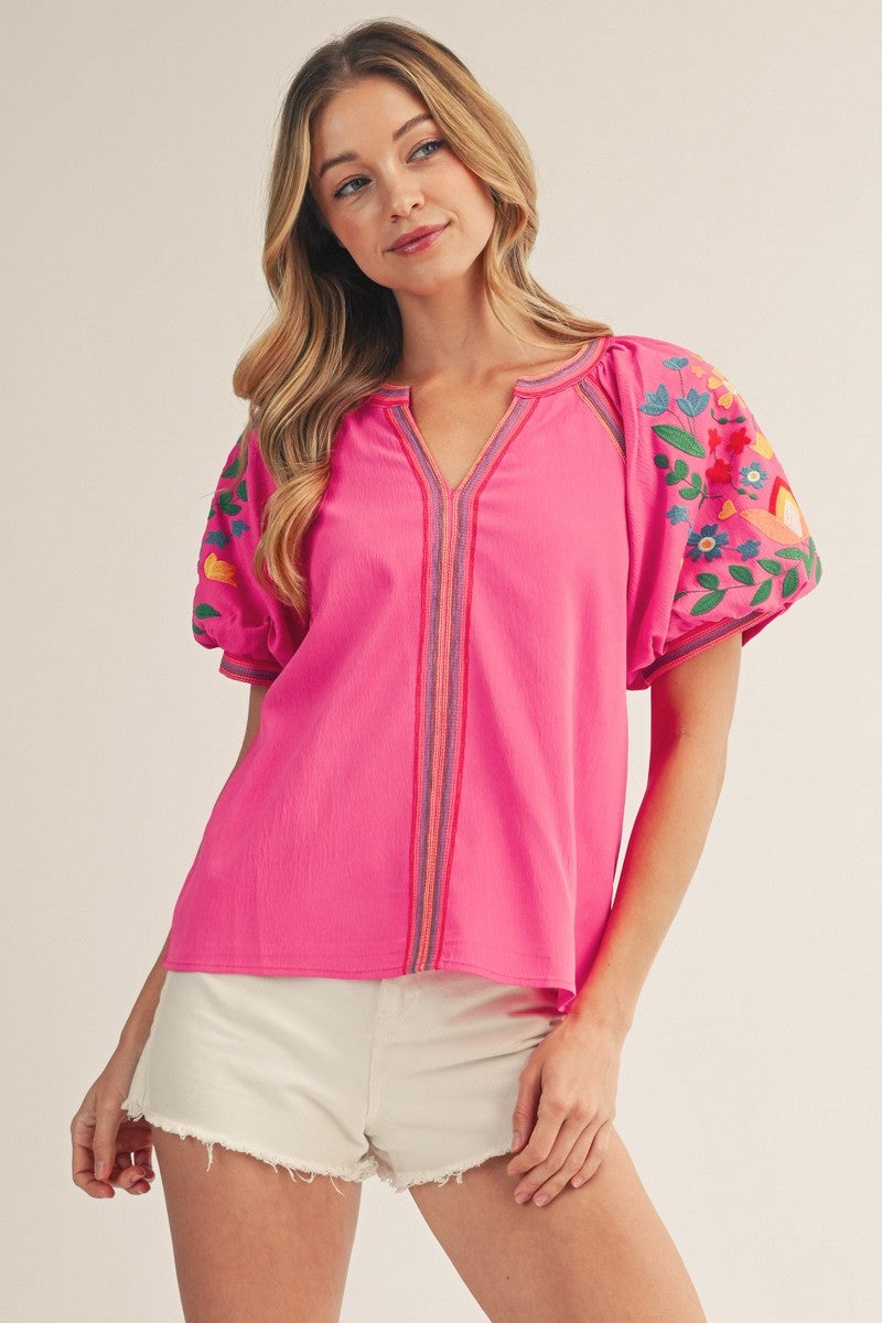 model wearing hot Pink top & cutoff white shorts