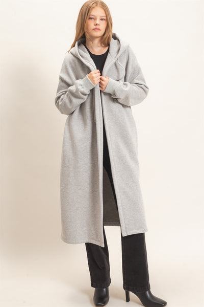 model wearing a black outfit with oversized long gray coat