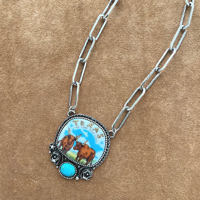 Texas longhorn necklace on tan background