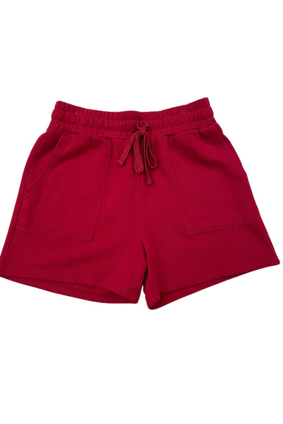 Red drawstring shorts with side pockets, photographed flat against a plain white background.