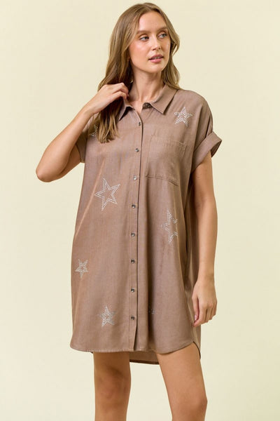 Woman wearing a brown shirt dress with star patterns on a beige background